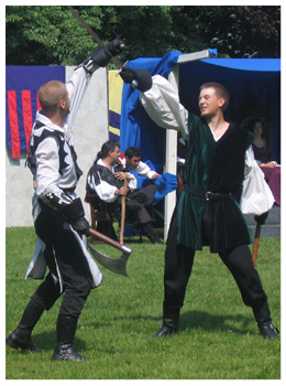 Two fighters begin their battle with an overhead clash of weapons.