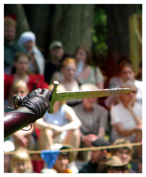 A knife cleaves through the air in the arena.
